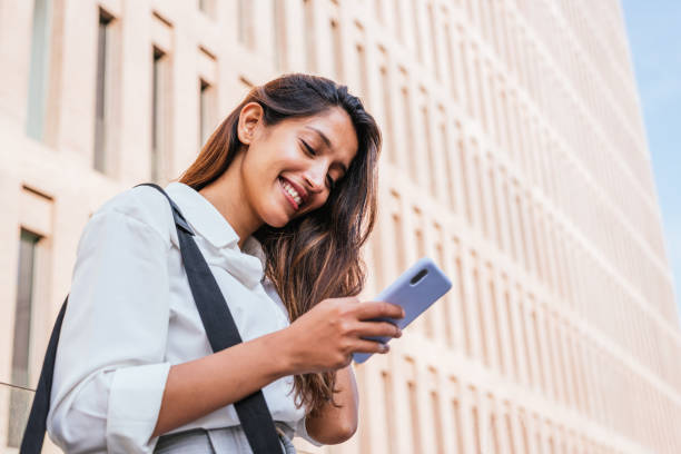 istock young indian female  sales woman using her smart phone before visiting a customer 1332991356