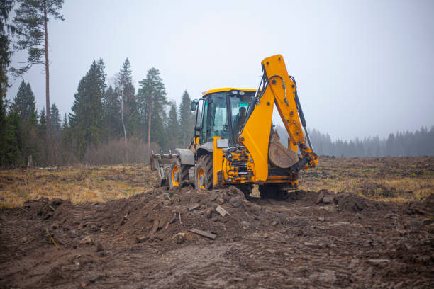 istock The tractor is driving through the mud. Heavy machinery for deforestation. 1332992596