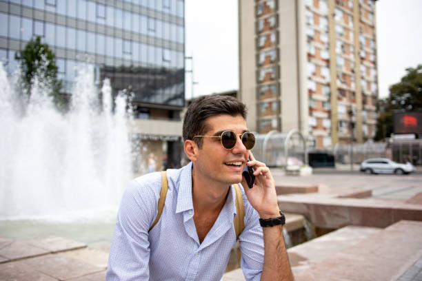 istock Handsome young man talking on a cellphone on the downtown 1332995083