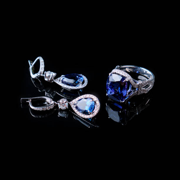 istock Ring and earrings in gold with diamonds on black 1332995114