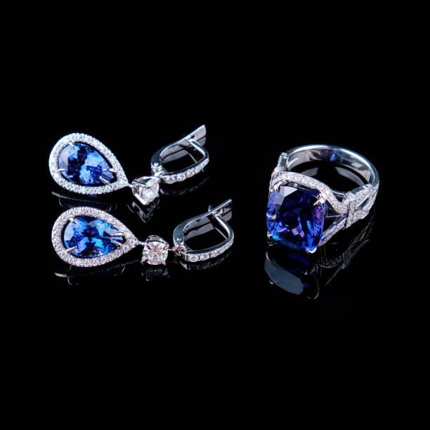 istock Ring and earrings in gold with diamonds on black 1332995117