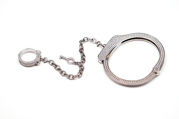 istock Jewelry.Gold bracelet and ring on a chain. 1332995136
