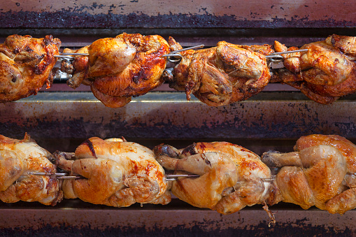 A rotisserie chicken is a chicken dish that is cooked on a rotisserie by using direct heat in which the chicken is placed next to the heat source.