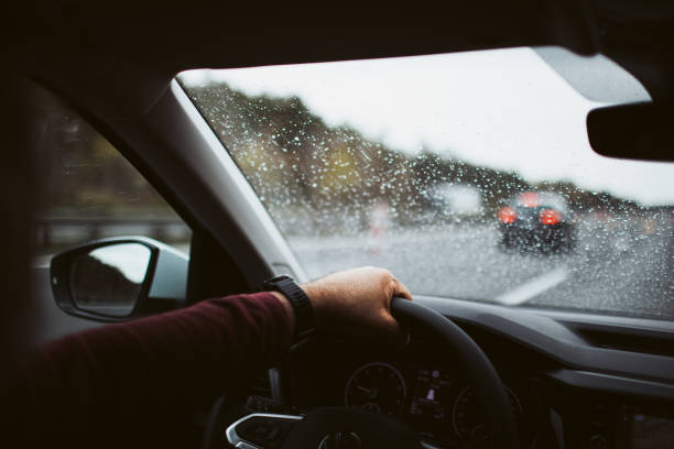 istock Male hand on the steering wheel on the highway 1332999271
