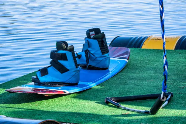 Equipment, boots, board, rope for wakeboarding on the sea on summer day.