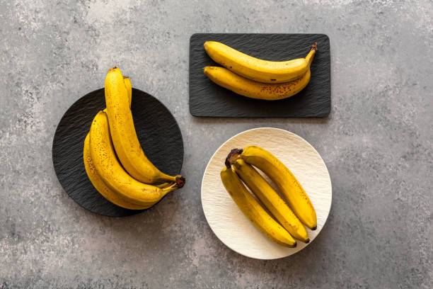 istock Banana on textured black plate. 1333002503