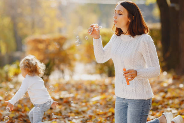 istock Mother with little daughter playing with a bubbles 1333005102
