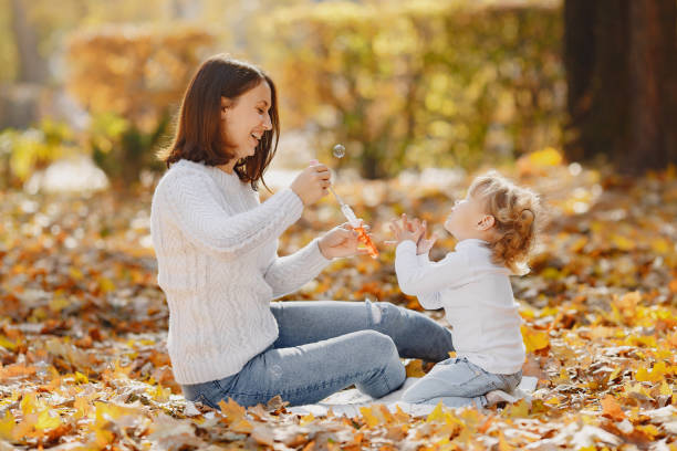 istock Mother with little daughter playing with a bubbles 1333005110