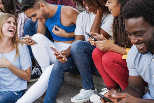 istock Happy young people using smartphones outdoor - Diversity and millennial generation concept - Focus on right girl hands 1333008205
