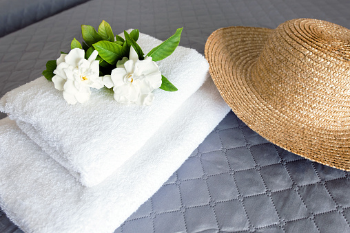 Hat and flowers on a beach towel