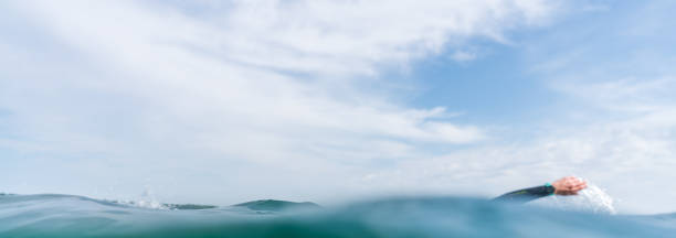 istock Water surface with an arm of a triathlete in background 1333011421