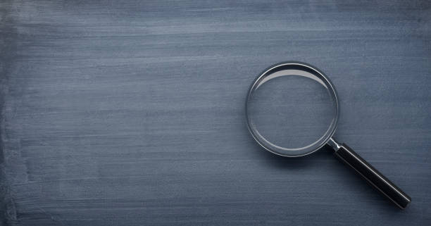 istock Magnifying glass on chalkboard background 1333012258
