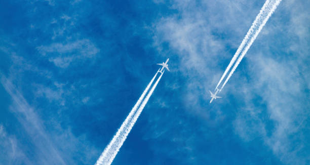 Airplanes in the sky Airplanes flying with high speed on blue sky background seen from the ground. airplane crash photos stock pictures, royalty-free photos & images