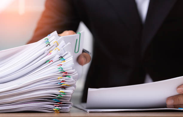 istock Business man or office workers holding documents for writing on office desk 1333014509