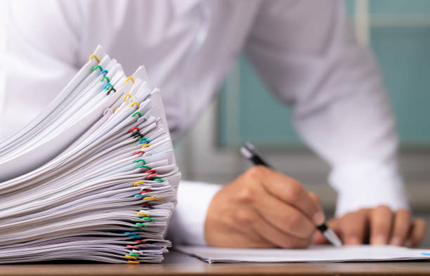 istock Business man or office workers with white shirt holding documents for writing on office desk 1333014514