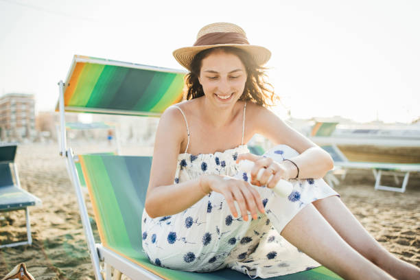 istock Woman apply sunscreen on the beach 1333020675