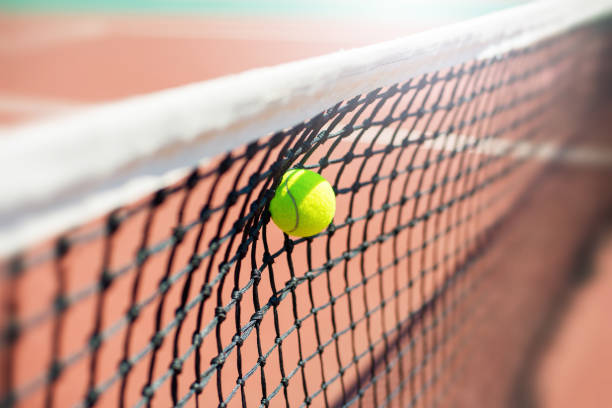 istock Tennis ball hits in the net during game. 1333023303