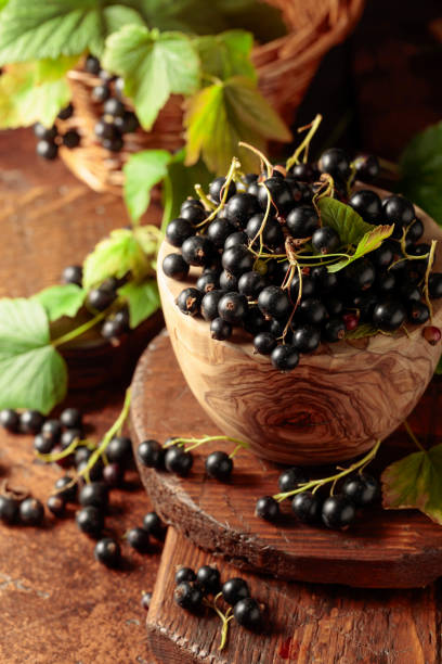 istock Ripe black currant on a brown table. 1333026557