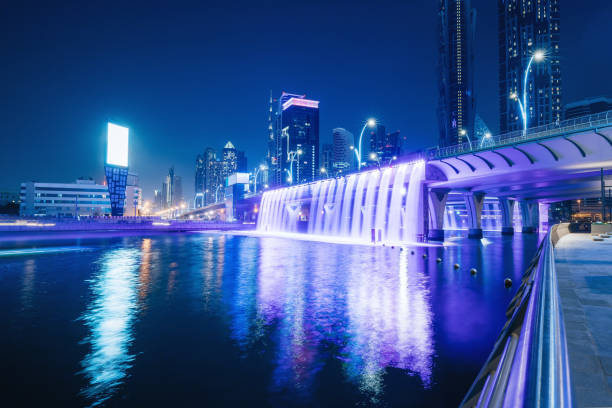 istock Illuminated waterfall bridge in downtown Dubai at night with thousands of small lights on high skyscrapers. Popular tourist attractions in UAE 1333029830