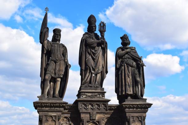 The statue of Saints Norbert of Xanten, Wenceslas and Sigismund on Charles Bridge in Prague. The statue of Saints Norbert of Xanten, Wenceslas and Sigismund on the medieval gothic Charles Bridge in Prague built on the 15th century. prague art stock pictures, royalty-free photos & images