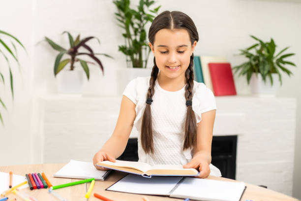 istock Cute pupil working at her desk. 1333034985