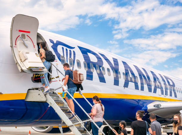 Passengers boarding on a Ryanair plane at Timioara Traian Vuia International Airport Timisoara, Romania - 06.20.2021: Passengers boarding on a Ryanair plane at Timioara Traian Vuia International Airport flapping wings photos stock pictures, royalty-free photos & images