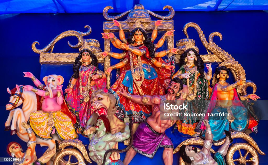 Idols of Hindu Goddess Maa Durga with her childrens during the Durga Puja festival. Durga Puja or Durgotsava,is an annual Hindu festival celebrated mainly in West Bengal,Indian.Durga is Goddess riding a lion with many arms each carrying weapon and defeating evil power of Mahishasura. Durga Stock Photo