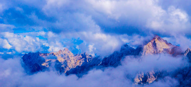 istock Peaks of Mountains Alps between Clouds 1333037663