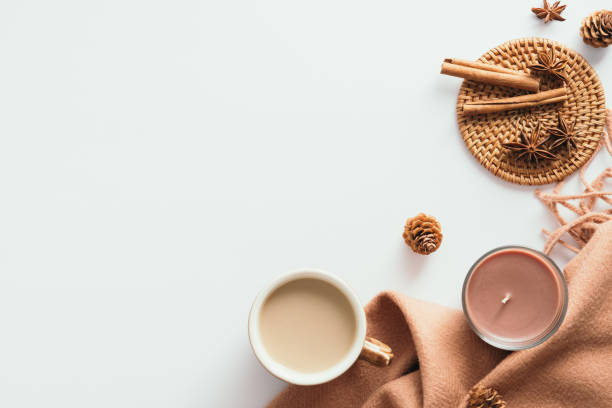 istock Cozy home desk table with plaid, coffee cup, candle on white background. Top view, flat lay, copy space. Autumn composition. Nordic hygge style concept. 1333039471