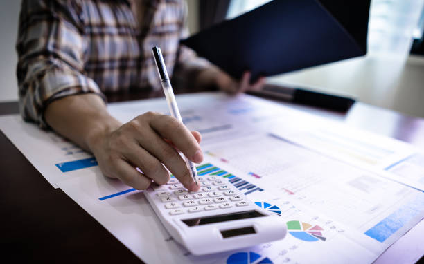 istock Finance and Accounting concept. Close up Businessman using calculator for do math finance and reading document from business document folder. 1333039699
