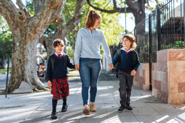 istock Mother with kids going to school 1333041903