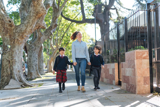 istock Mother with kids going to school 1333043003