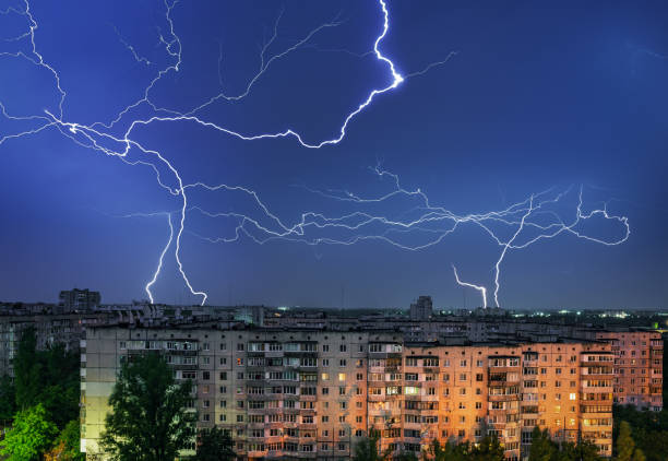 istock Thunderstorm with lightning above the night city 1333047908