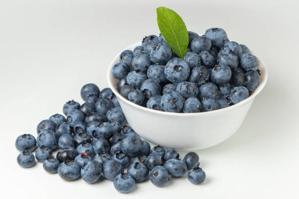 istock Blueberries in bowl isolated on white background 1333051057