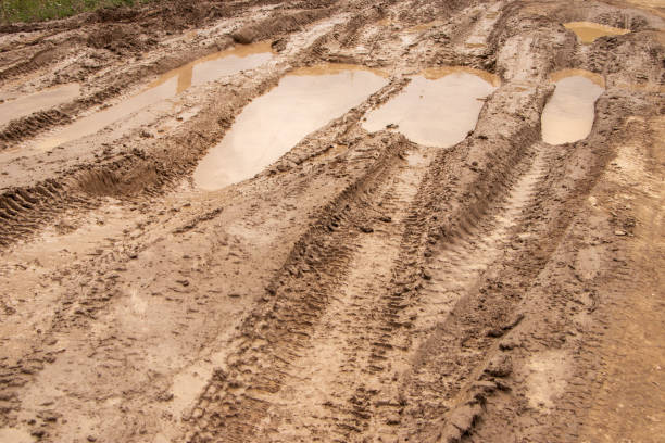 istock Dirty road. puddle with havy tires track 1333051241