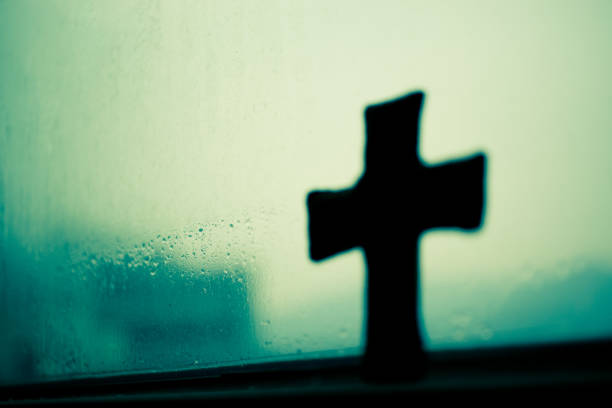 istock A faint window, a wooden cross. 1333054259