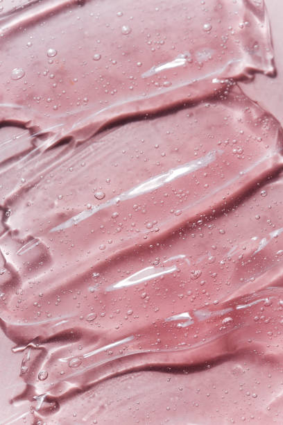 istock Liquid gel or serum drops  on pink background in macro. 1333055611