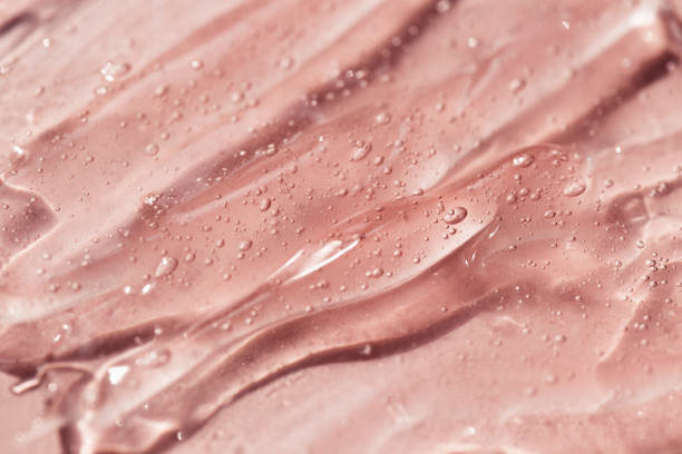 istock Liquid gel or serum drops  on pink background in macro. 1333055619