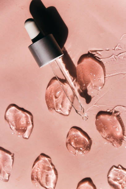 istock Liquid gel or serum drops  on pink background in macro. 1333055624