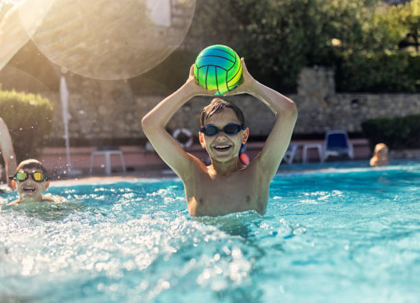 Kids playing ball in swimming pool