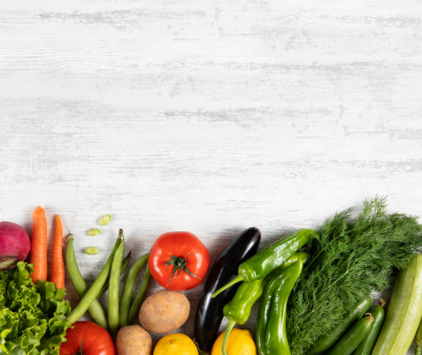 istock Fresh Vegetables on White Wooden Background 1333057905