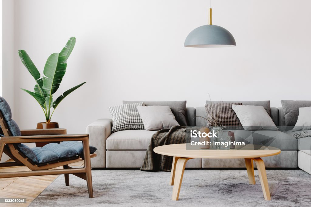 Modern Living Room Interior Design Modern living room setup with classic parquet floor. Furnished with light gray sofa, blue arm chair with wooden frame, modern blue ceiling lamp, wooden coffee table and gray carpet. Living Room Stock Photo