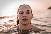 Young woman with wet hair in water