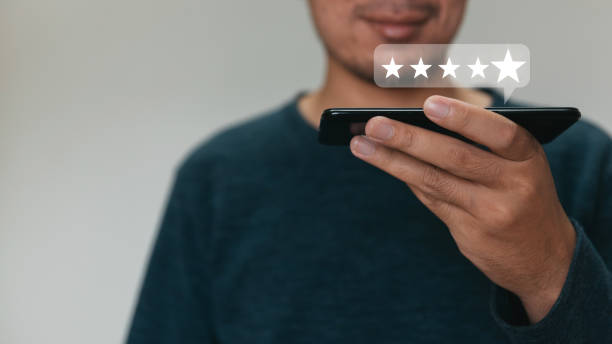 istock Customer hand  holding smart phone and five star with copy space. Best Excellent Services Rating for Satisfaction. Customer experience satisfaction concept. 1333064133