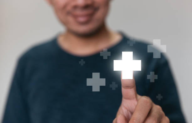 istock Handsome man touching plus sign icon means to offer positive thing. 1333064147