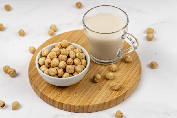 istock Hazelnut milk in a glass with nuts on a wooden table 1333064357