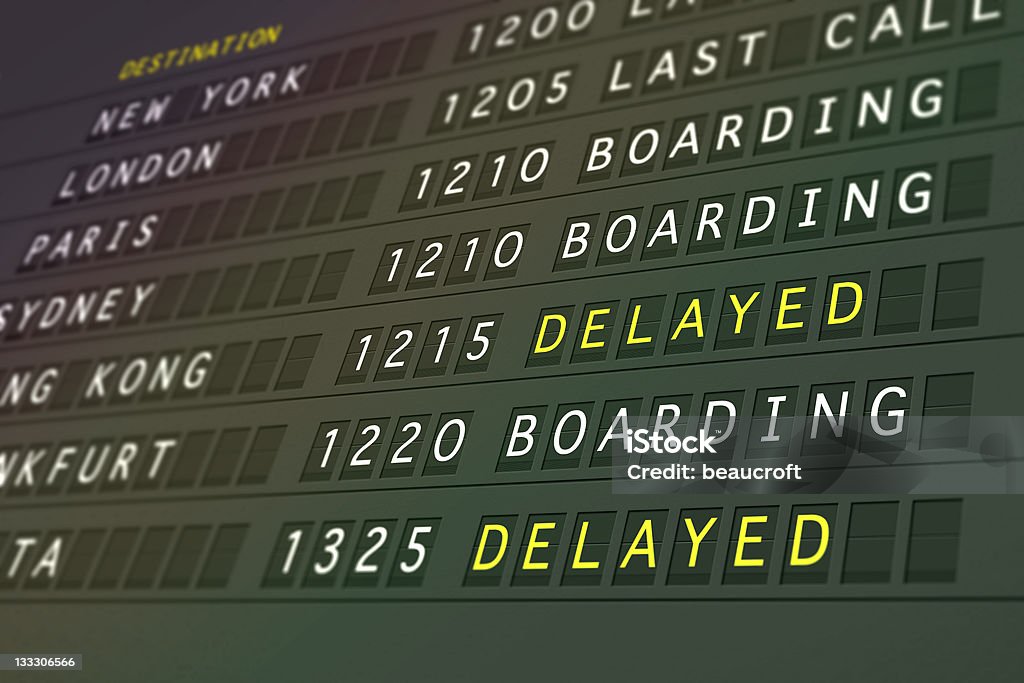 Flights delayed Airport information sign showing flights delayed. Arrival Departure Board Stock Photo