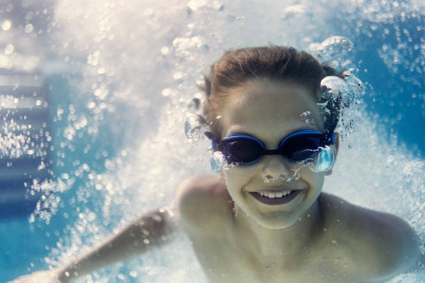 istock Little boy swimming underwater in pool 1333066673