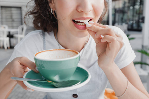 Woman finished her coffee and is going to chew gum to clean her teeth from plaque and freshen her breath. Dental health concept Woman finished her coffee and is going to chew gum to clean her teeth from plaque and freshen her breath. Dental health concept mint chewing gum stock pictures, royalty-free photos & images