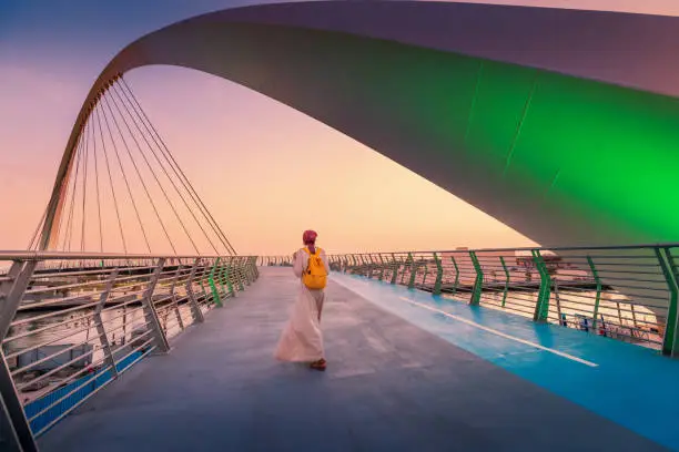 Photo of Woman tourist walks on the tolerance suspension bridge in Dubai. Popular travel attractions in the United Arab Emirates